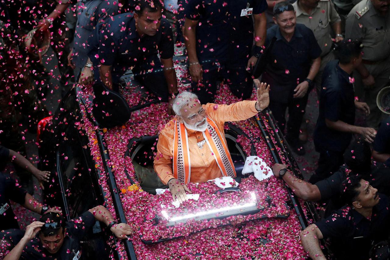 FILE PHOTO: India's Prime Minister Narendra Modi waves to supporters during a roadshow in Varanasi