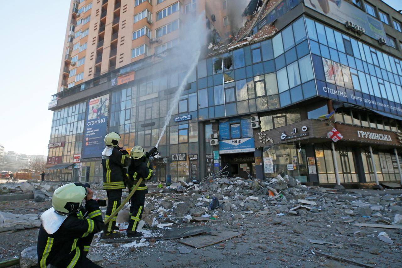 Firefighters extinguish fire in an apartment building damaged by recent shelling in Kyiv