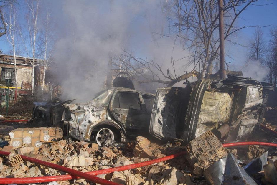 Destroyed cars are seen in an area damaged by shelling in Kyiv