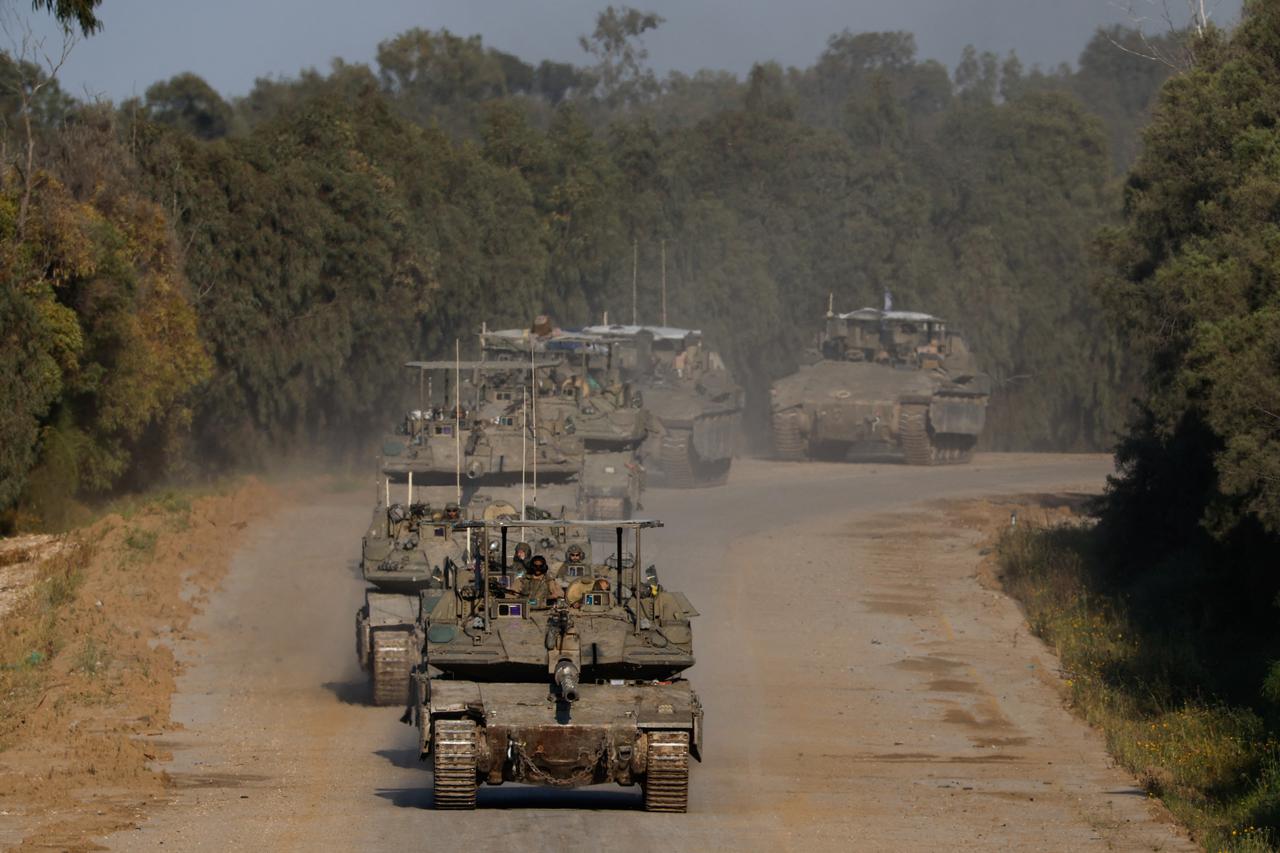 Israeli tanks and armoured personnel carriers (APC) manoeuvre near the Israel-Gaza border