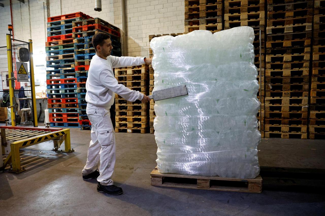 FILE PHOTO: An ice factory worker arranges bags for storage in San Fernando de Henares, Spain