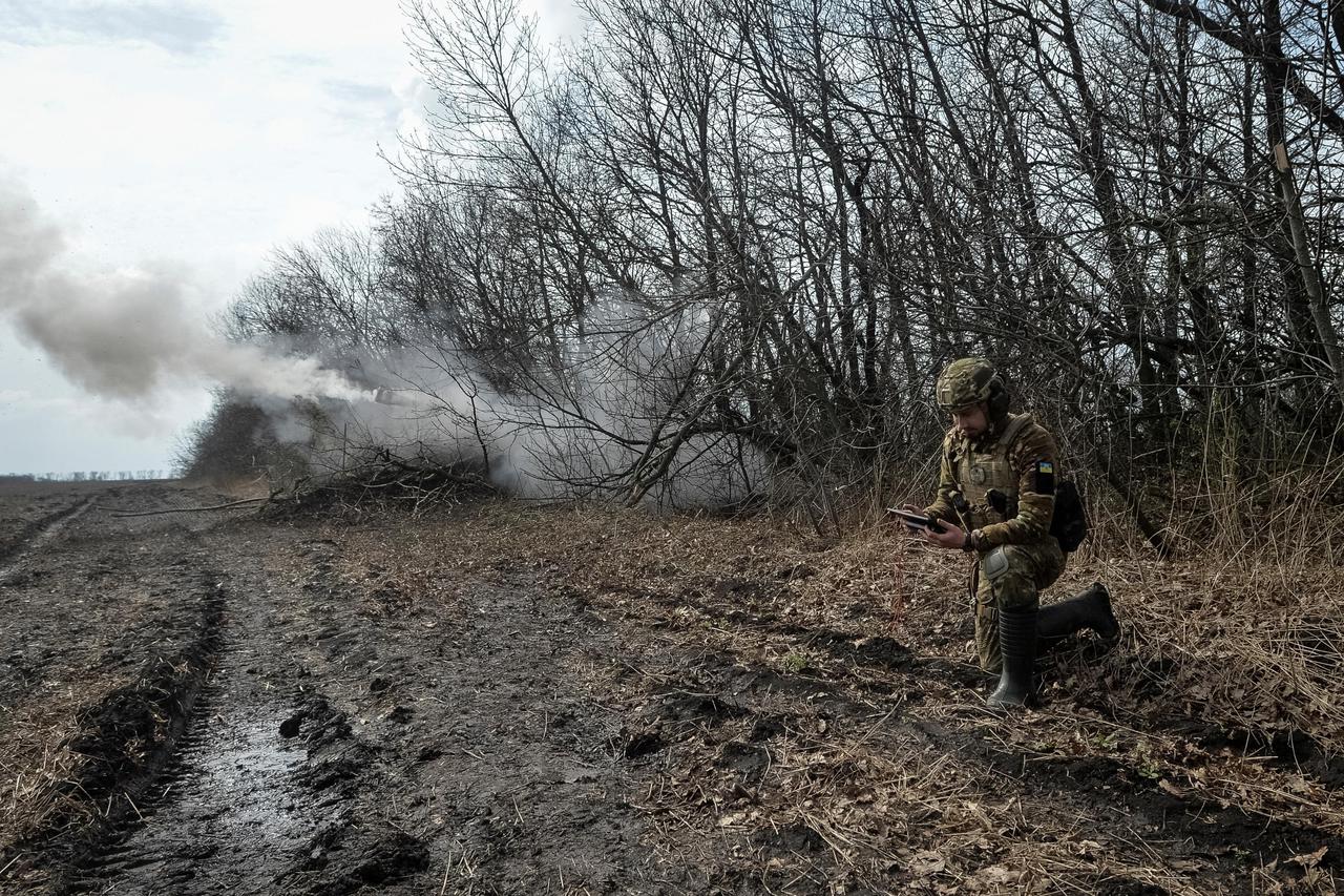 Ukrainian servicemen fire a self-propelled howitzer towards Russian troops near the front line city of Bakhmut
