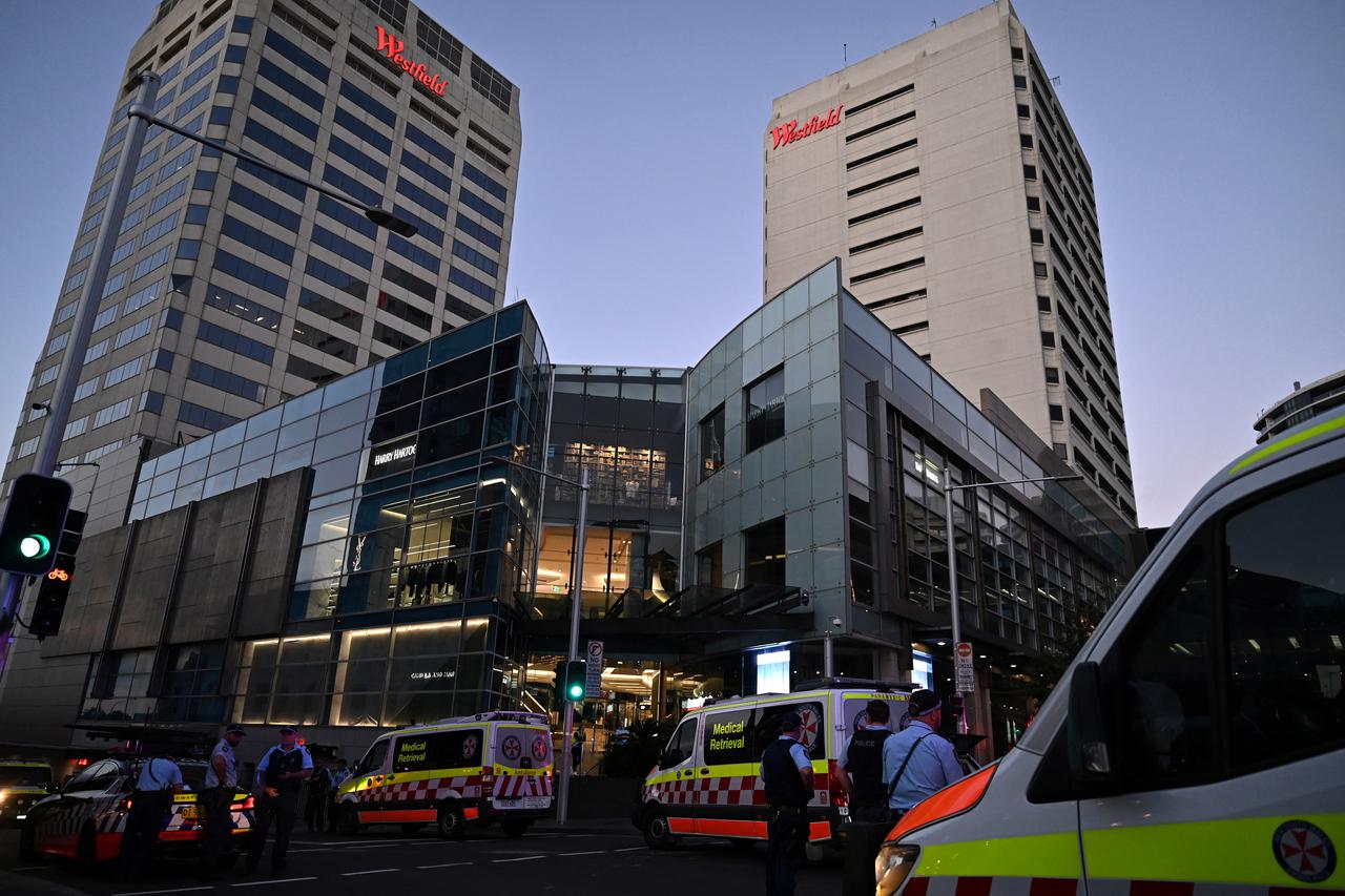 Emergency service workers stand near Bondi Junction after multiple people were stabbed inside the Westfield Bondi Junction shopping centre in Sydney