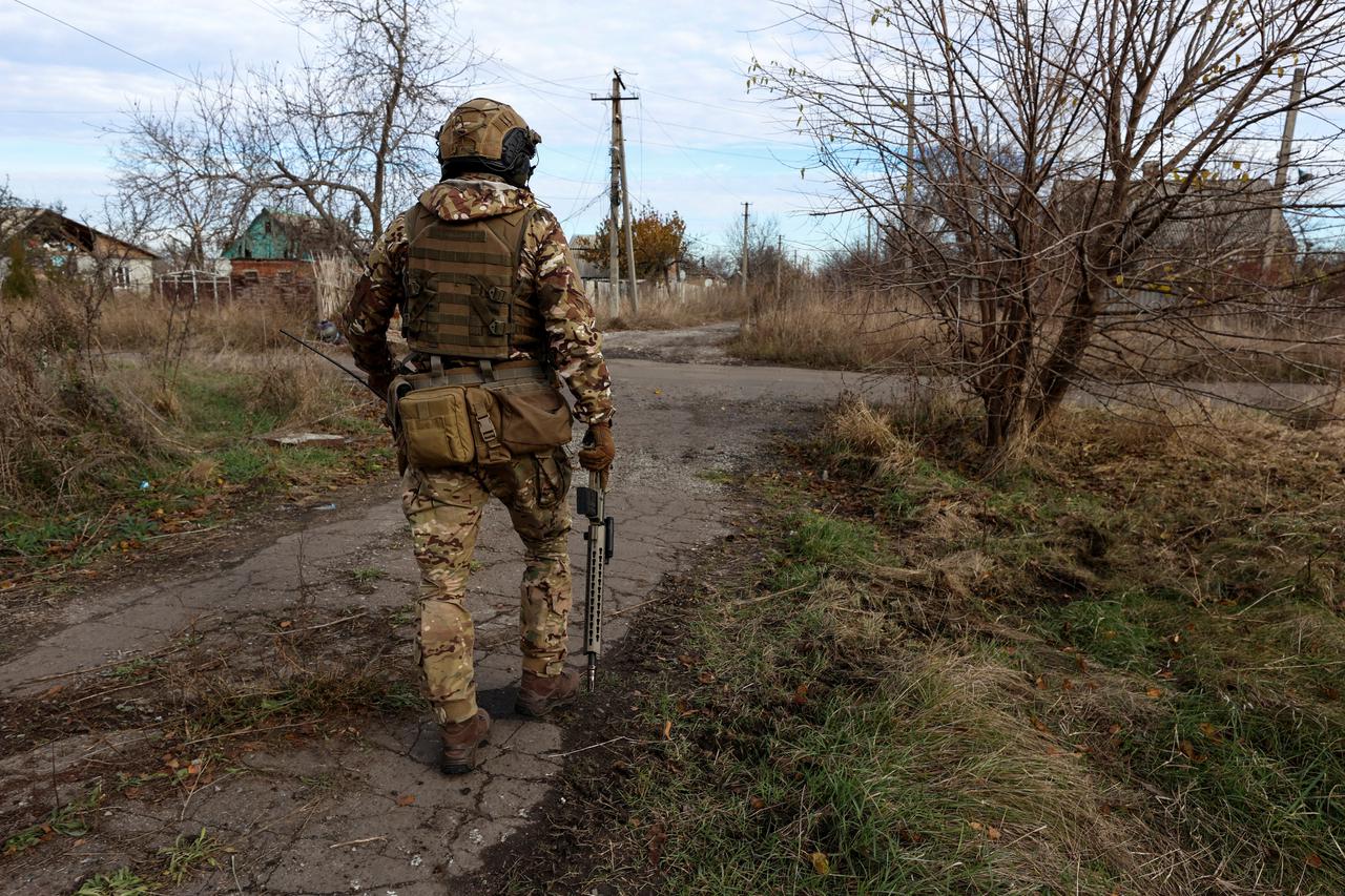 Member of Ukraine's National Guard Omega Special Purpose walks to a position in the front line town of Avdiivka