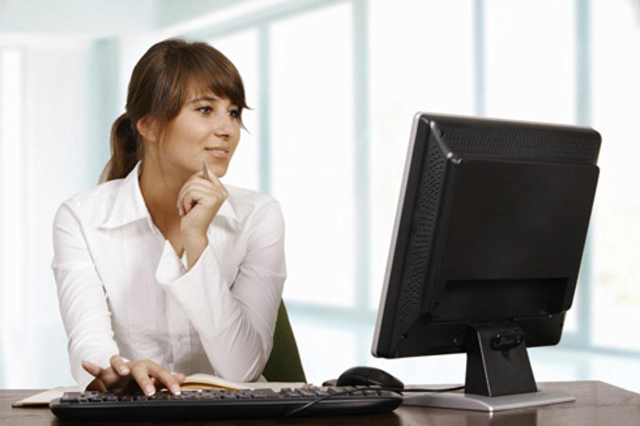 'Young woman working with computer'