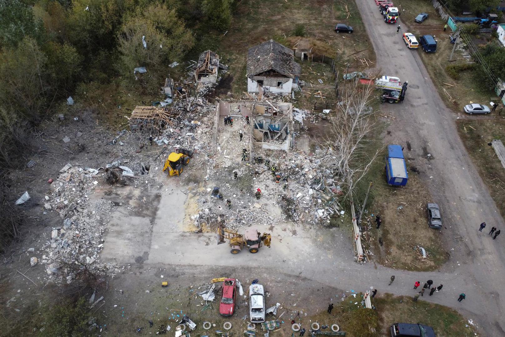 Rescues remove debris at a site of buildings of a local cafe and a grocery store, where at least 52 people were killed by a Russian missile strike, amid Russia's attack on Ukraine, in the village of Hroza, in Kharkiv region, Ukraine October 6, 2023. REUTERS/Yan Dobronosov Photo: Stringer/REUTERS