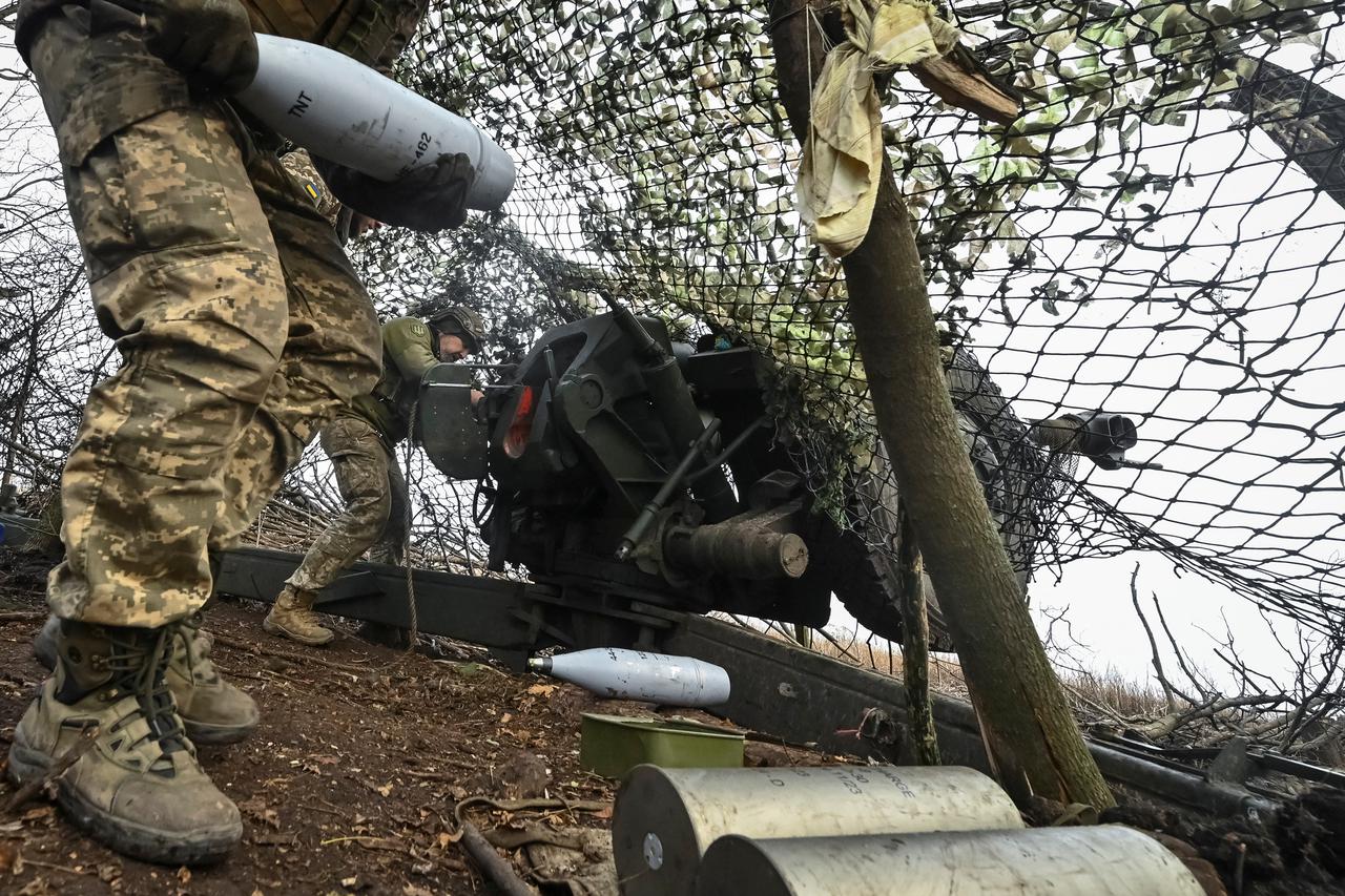 Ukrainian servicemen fire a D-30 howitzer towards Russian troops at a position in a front line in Zaporizhzhia region