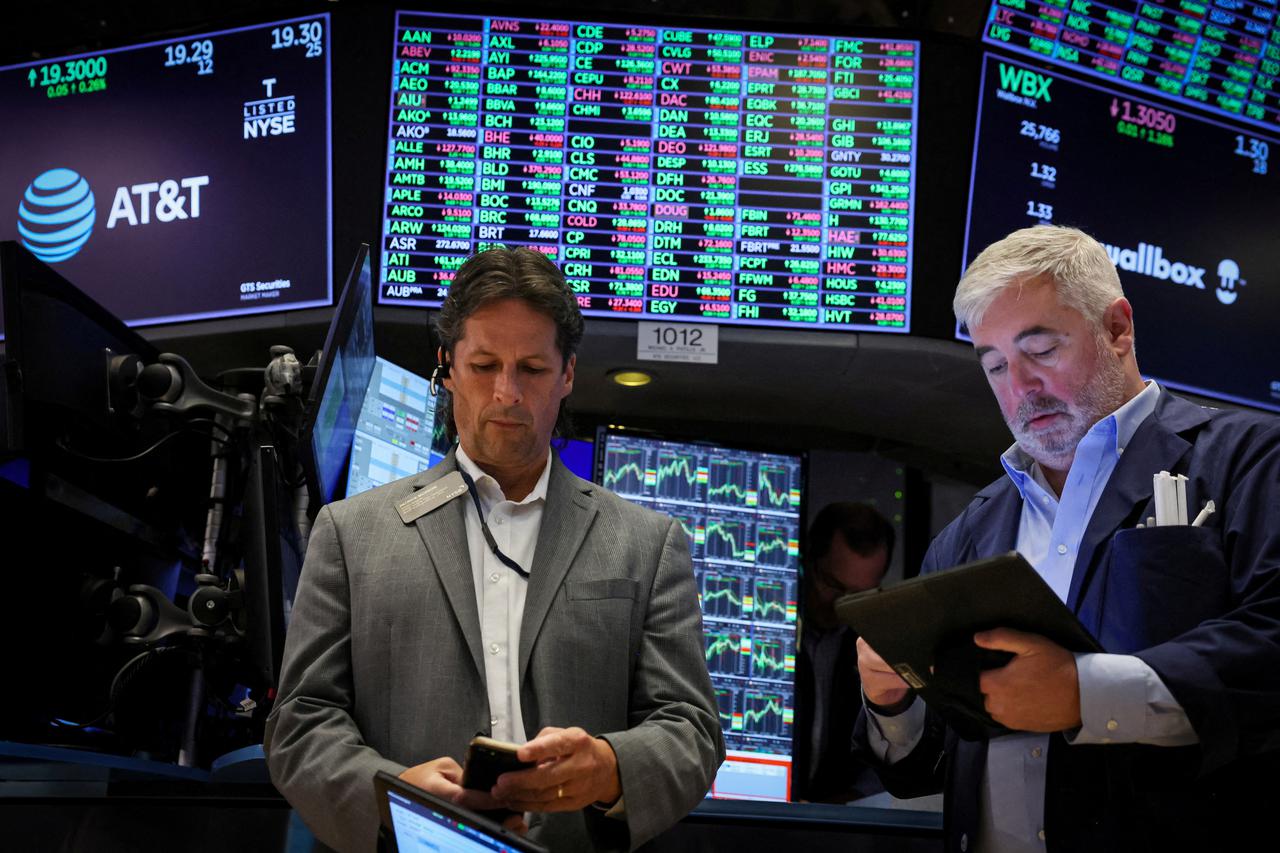 FILE PHOTO: Traders work on the floor of the NYSE in New York