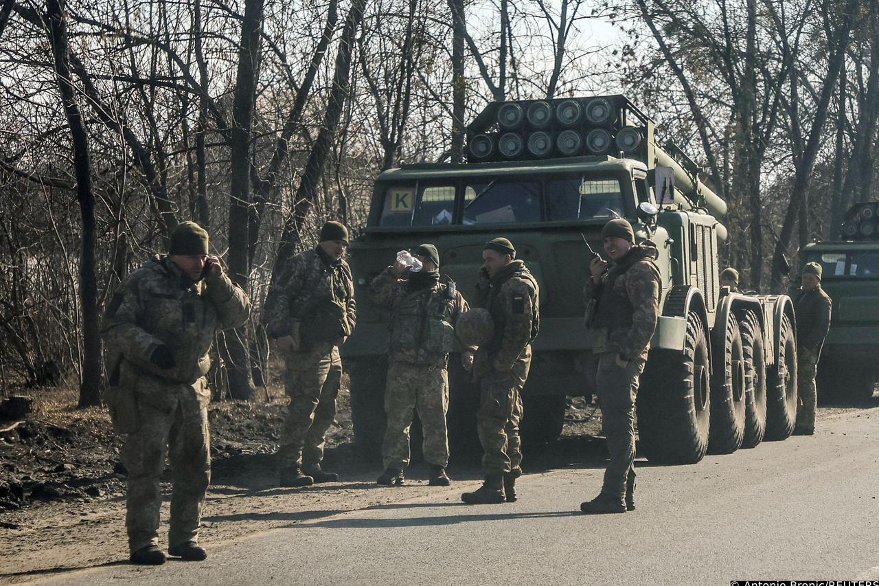 Ukrainian army soldier are seen next to multiple launch missile systems in Kharkiv region