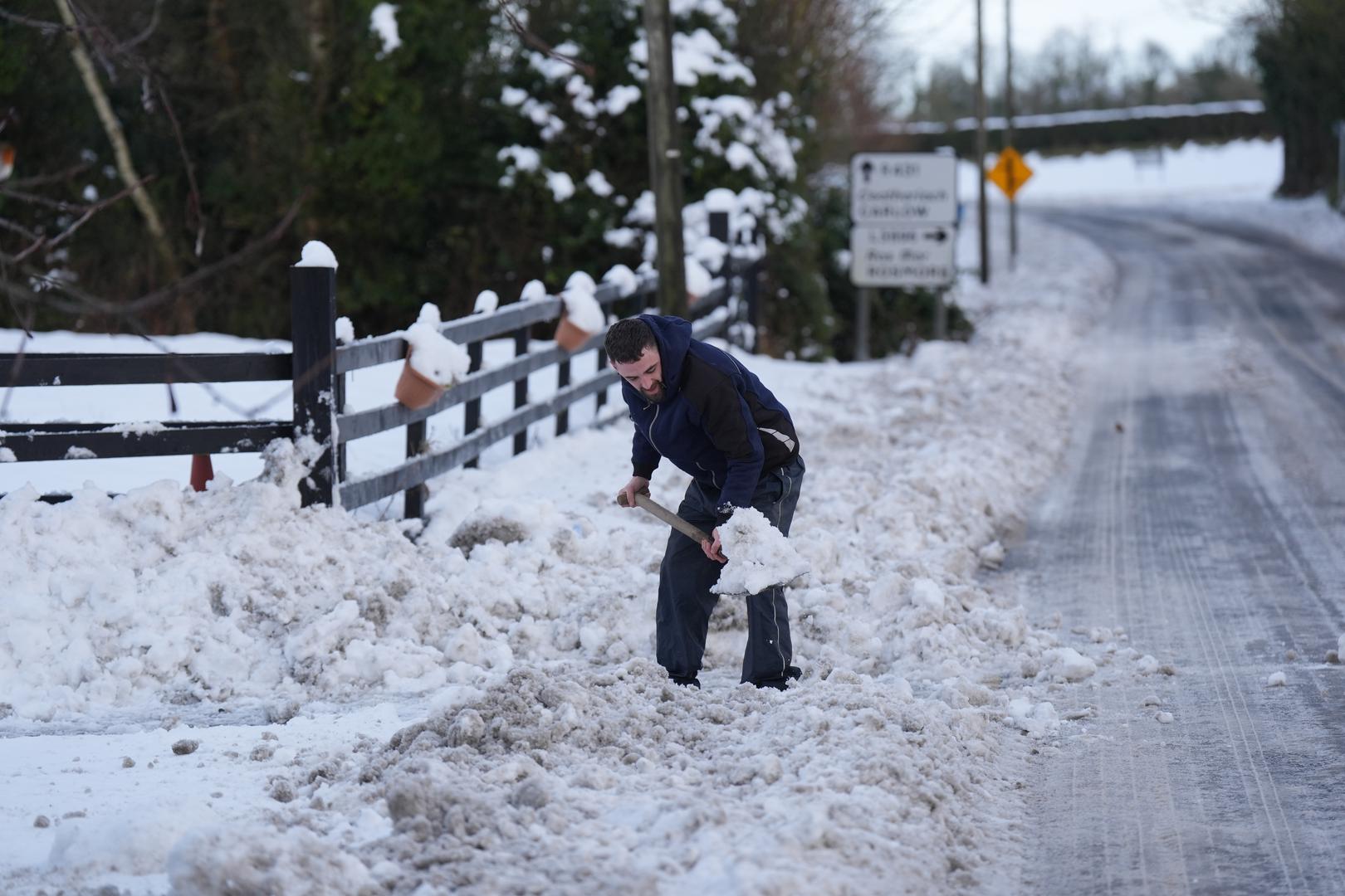 A man clears snow in Towlerton in County Laois in Ireland. Tens of thousands of homes and businesses in Ireland are without water and electricity amid a bitter cold snap across the whole island. Picture date: Monday January 6, 2025. Photo: Niall Carson/PRESS ASSOCIATION