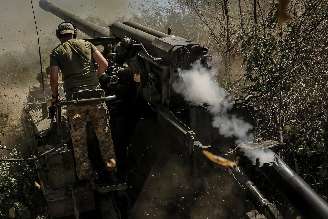 Ukrainian servicemen fire a self-propelled howitzer towards Russian troops at a frontline near the town of Chasiv Yar