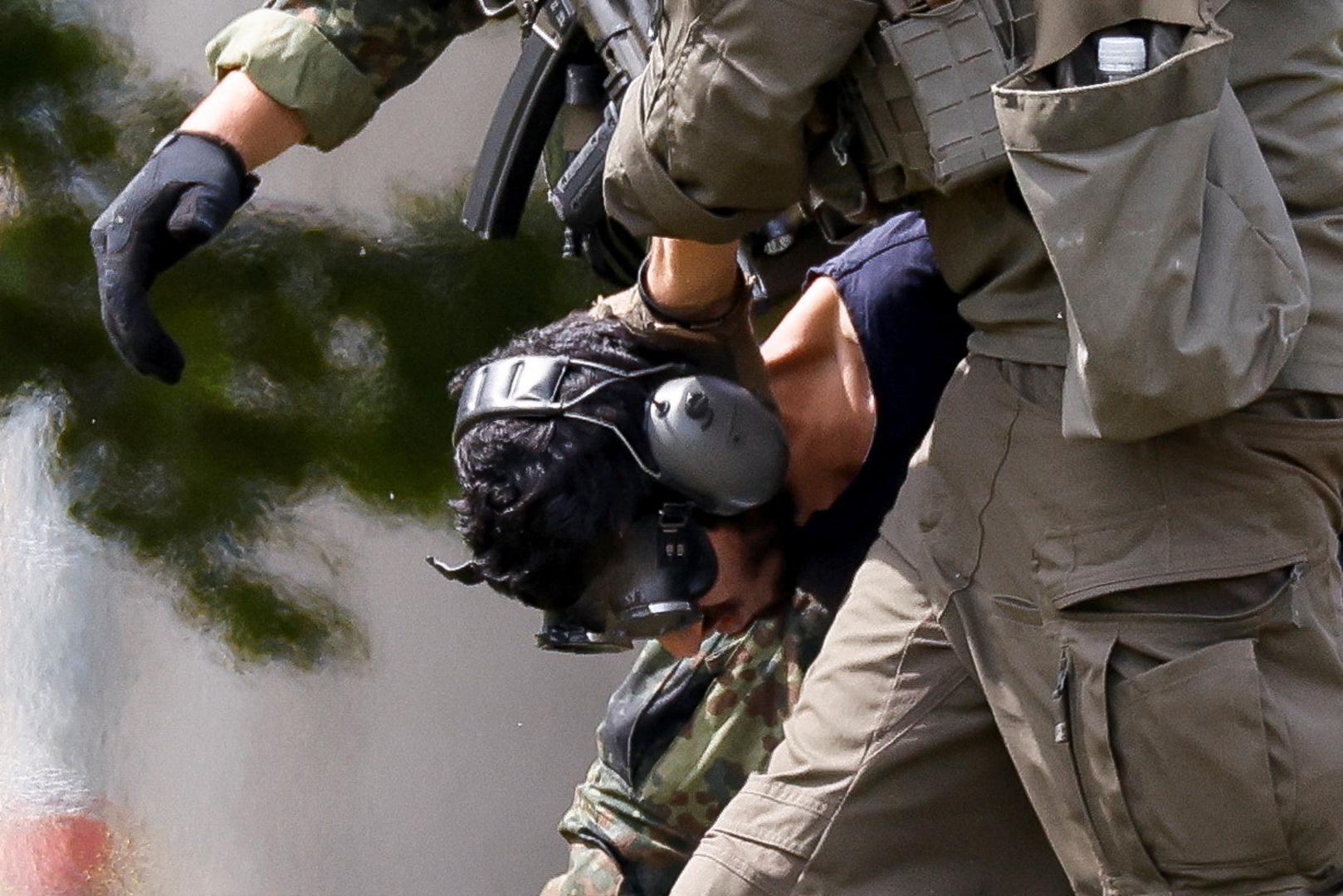 A 26-year-old Syrian man, who is the suspect in custody for a stabbing rampage in the western German city of Solingen in which several individuals were killed, is escorted by police on his way to the Federal Public Prosecutor in Karlsruhe, Germany, August 25, 2024. REUTERS/Heiko Becker Photo: Heiko Becker/REUTERS