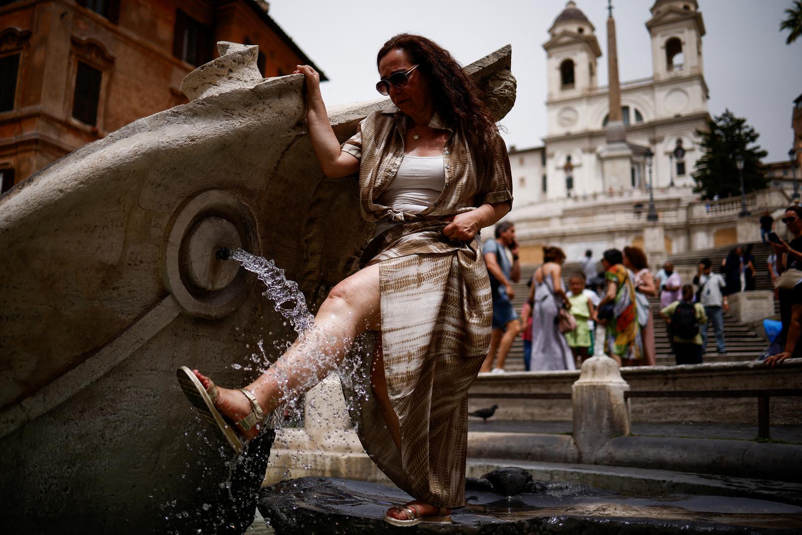 A woman cools off at the Fontana della Barcaccia at the Spanish Steps amid a heatwave in Rome, Italy, June 20, 2024. REUTERS/Guglielmo Mangiapane Photo: GUGLIELMO MANGIAPANE/REUTERS