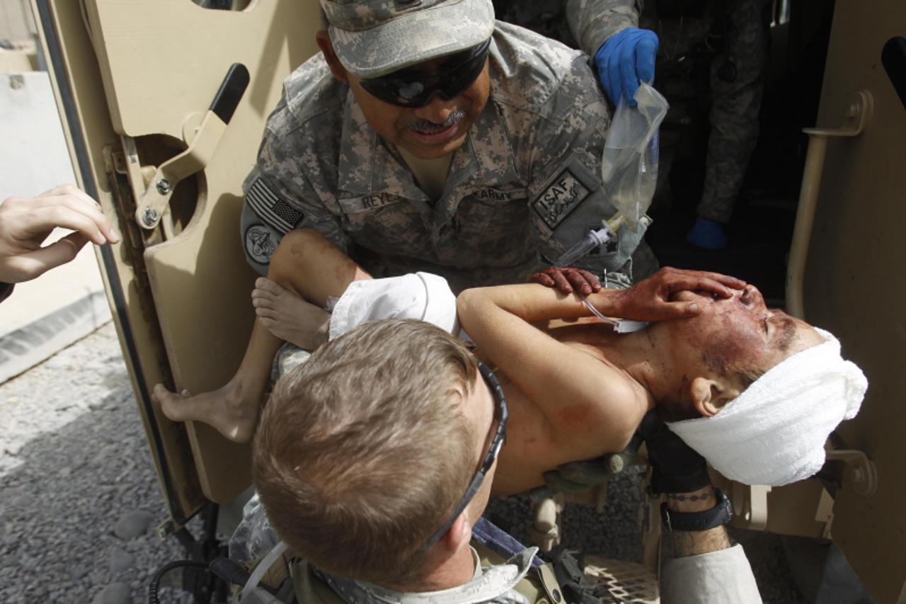 'ATTENTION EDITORS - VISUAL COVERAGE OF SCENES OF DEATH AND INJURY    U.S. Army soldiers from Delta Company, a part of Task Force 1-66 carry a wounded 7-year-old Afghan boy, a victim of a road side ex