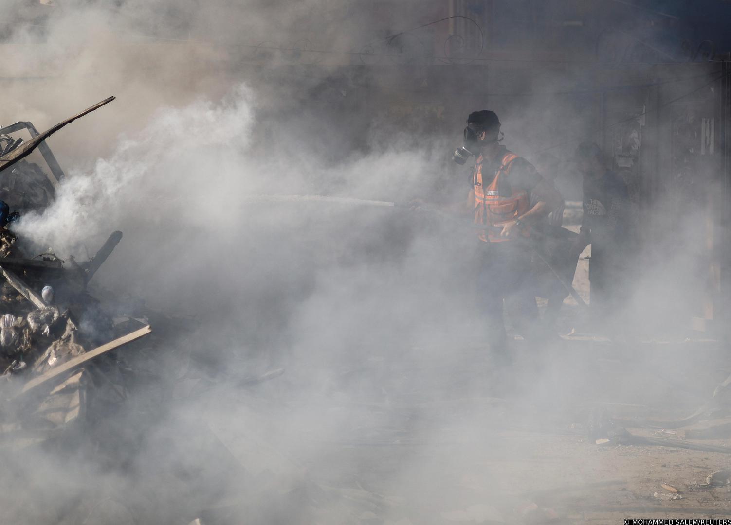 A Palestinian firefighter works to put out a fire at the site of Israeli strikes on a residential building, amid the ongoing conflict between Israel and Palestinian Islamist group Hamas, in Khan Younis in the southern Gaza Strip, November 7, 2023. REUTERS/Mohammed Salem Photo: MOHAMMED SALEM/REUTERS