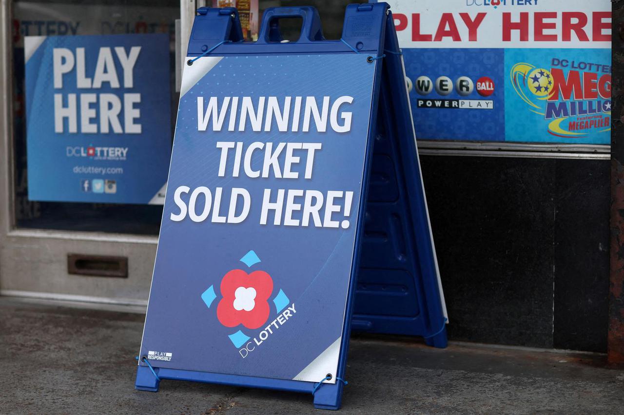 FILE PHOTO: Lotto ticket signs advertising Mega Millions and the Powerball