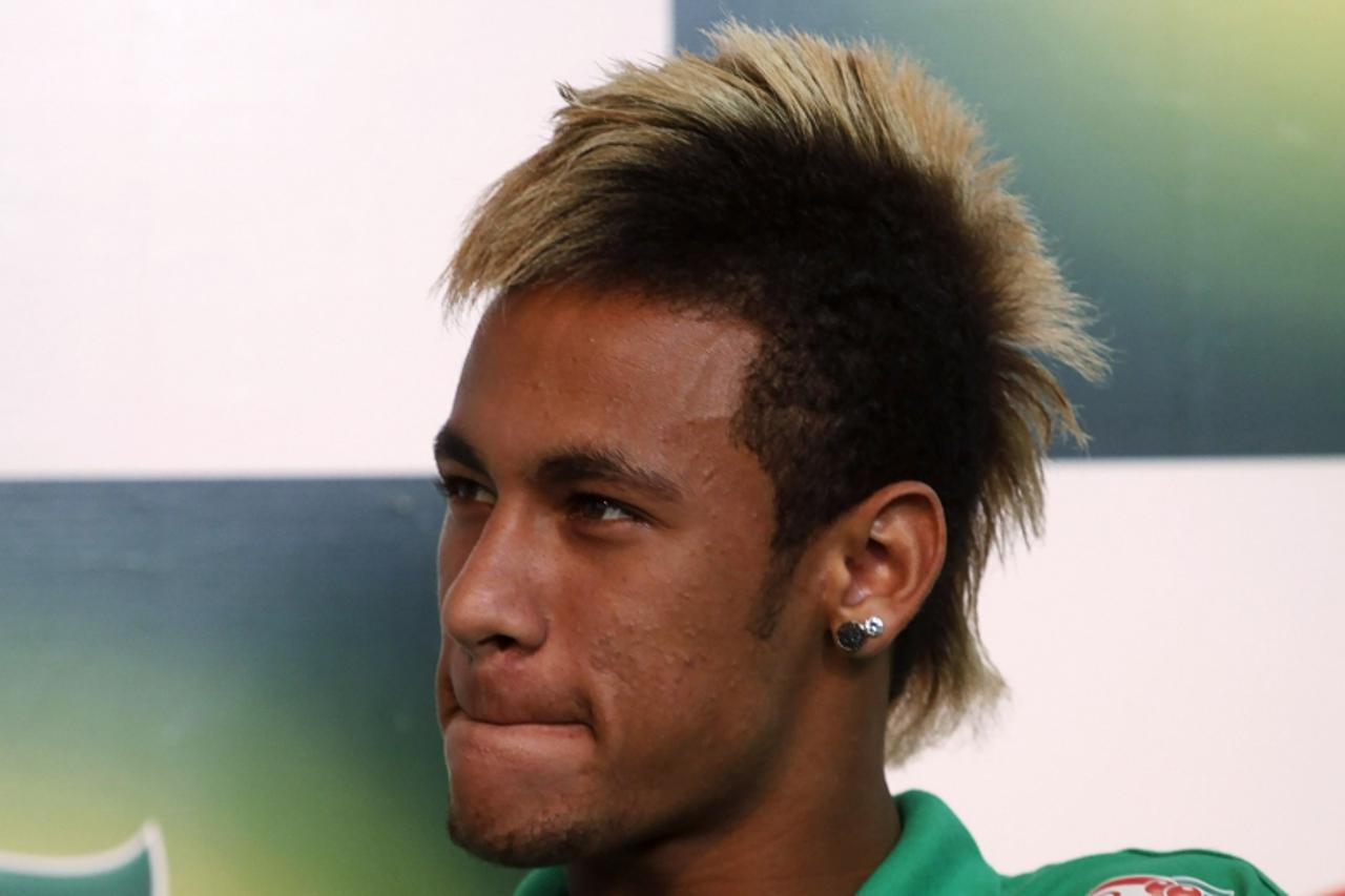 'Neymar of Brazil\'s Santos listens to a journalist\'s question during a news conference in Sao Paulo October 24, 2011. REUTERS/Nacho Doce (BRAZIL - Tags: SPORT SOCCER HEADSHOT)'