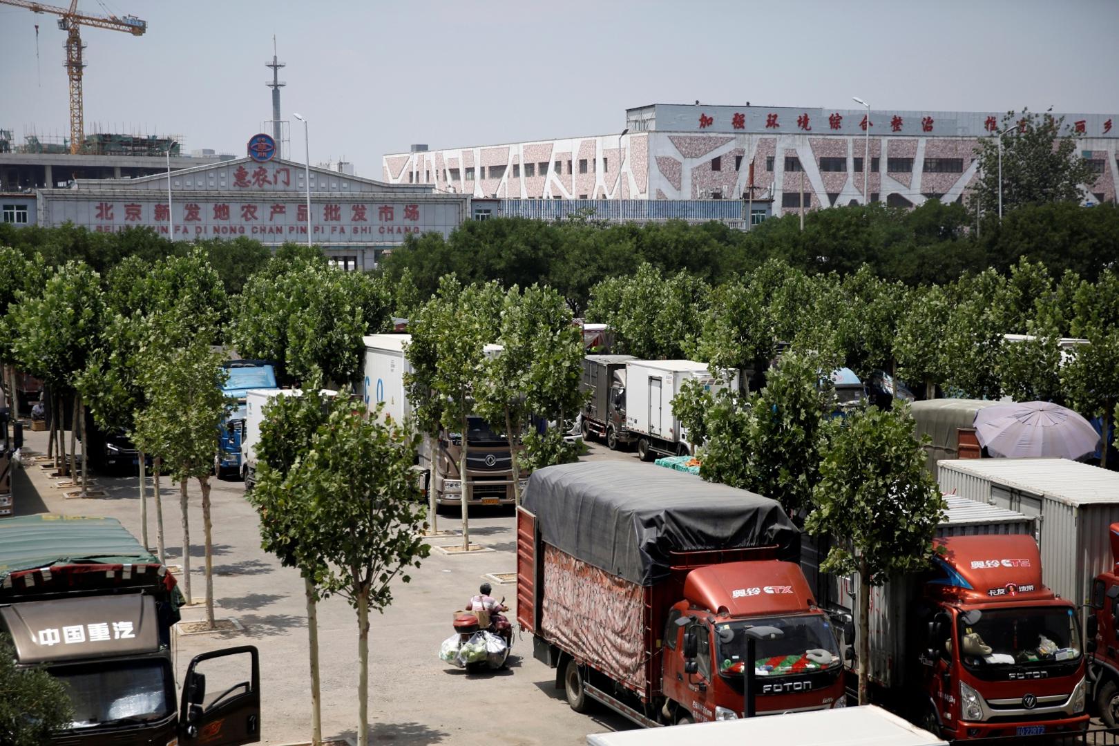 Man rides a vehicle with vegetables at a parking lot that has been converted into a temporary wholesale market in Beijing A man rides a vehicle with vegetables at a parking lot that has been converted into a temporary wholesale market after the Xinfadi wholesale market nearby was closed following cases of the coronavirus disease (COVID-19) infections, in Beijing, China June 16, 2020.  REUTERS/Tingshu Wang TINGSHU WANG