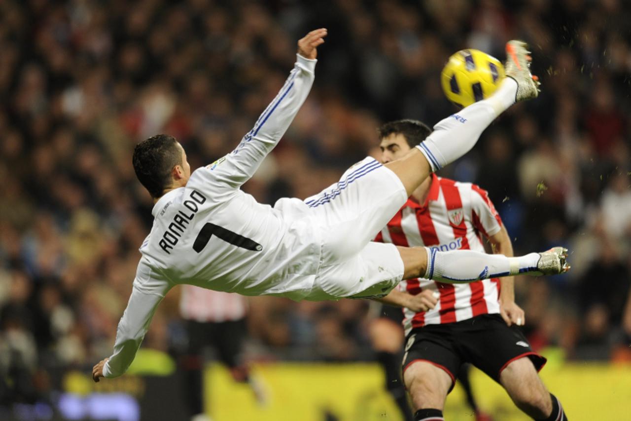 \'Real Madrid\'s Portuguese forward Cristiano Ronaldo jumps for the ball during a Spanish league football match against Athletic de Bilbao in the Santiago Bernabeu Stadium on November 20, 2010 in Madr