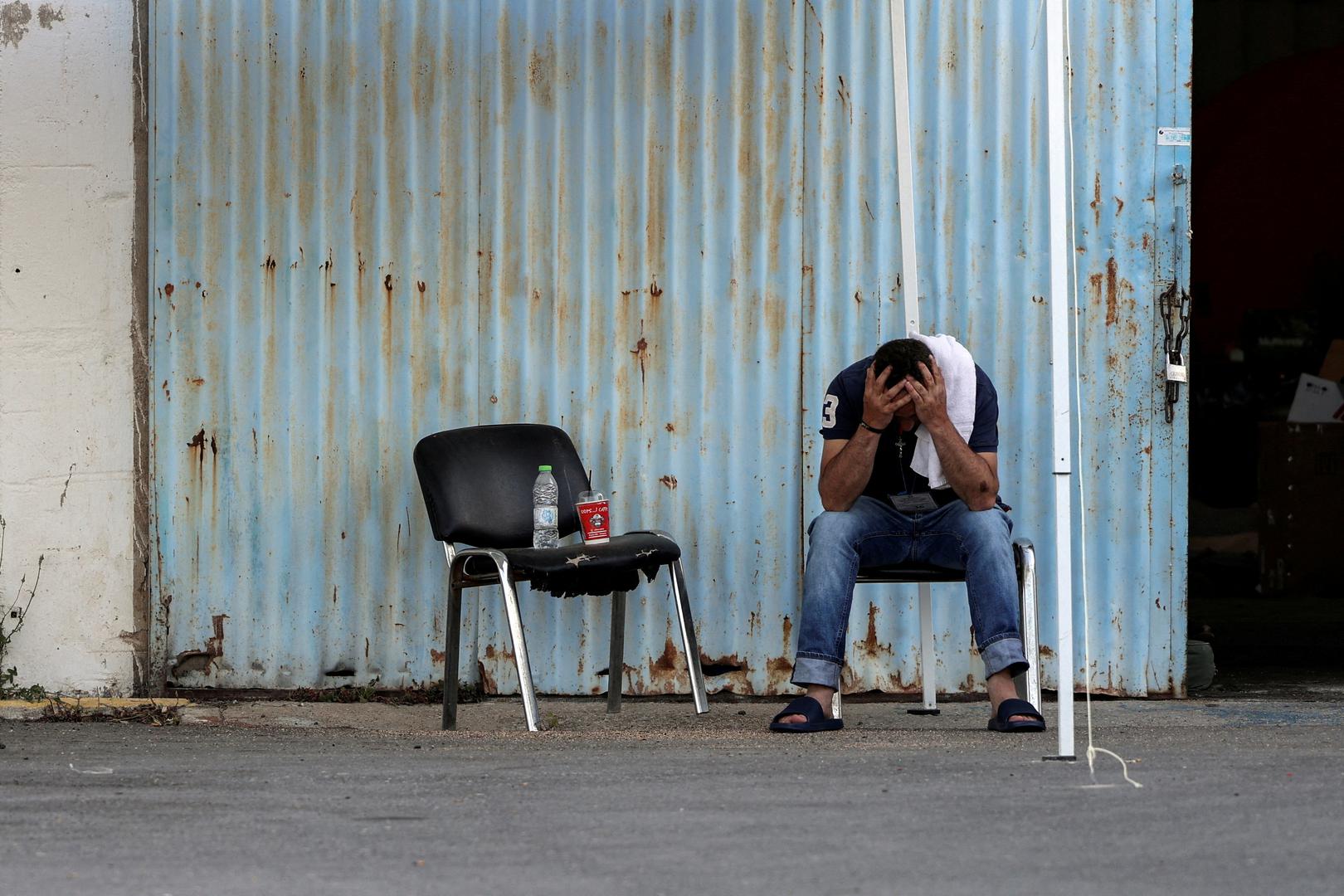 A migrant who was rescued at open sea off Greece along with other migrants, after their boat capsized, reacts outside a warehouse used as a shelter, at the port of Kalamata, Greece, June 15, 2023. REUTERS/Stelios Misinas     TPX IMAGES OF THE DAY Photo: STELIOS MISINAS/REUTERS