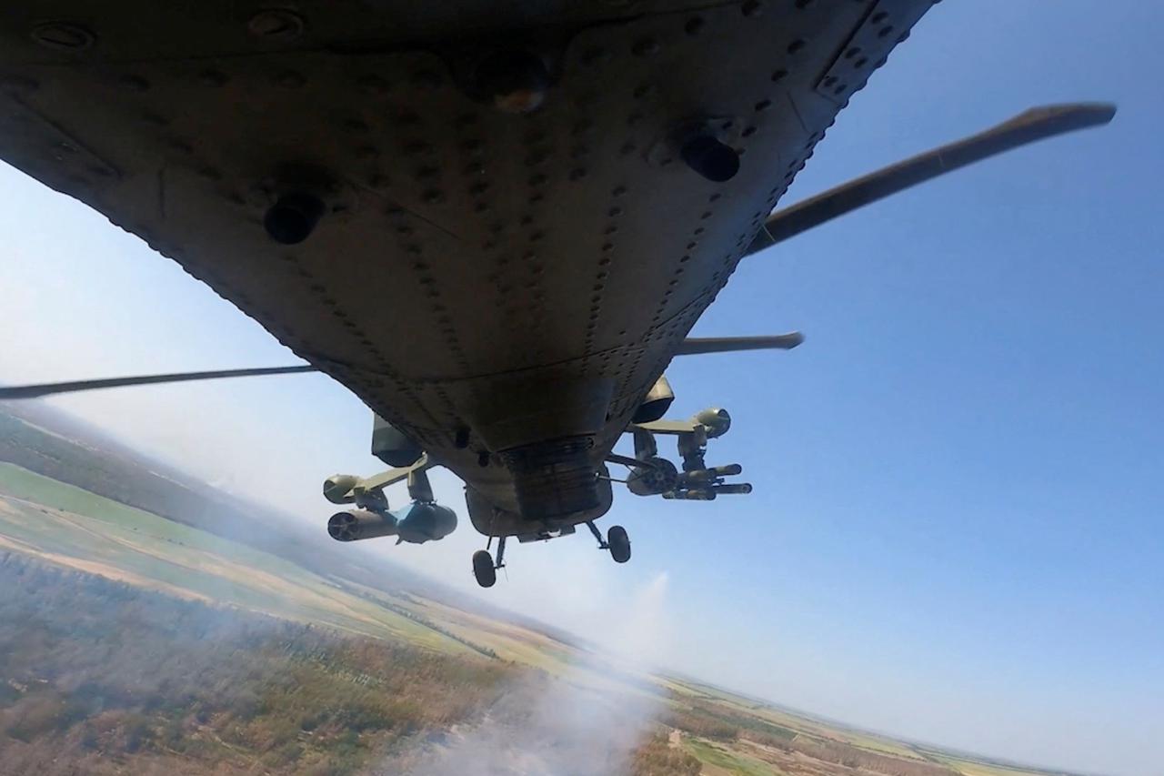 A Russian military helicopter fires following Ukraine's incursion into the border area in the Kursk region