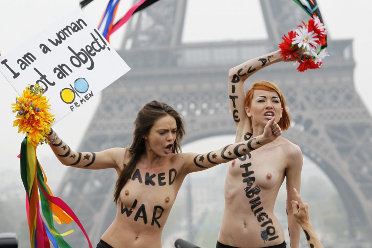 'Activists of the Ukrainian women\'s movement Femen protest near the Eiffel Tower against what they say is the anti-women policy of Islam, in Paris March 31, 2012. The Femen activists undressed to pro