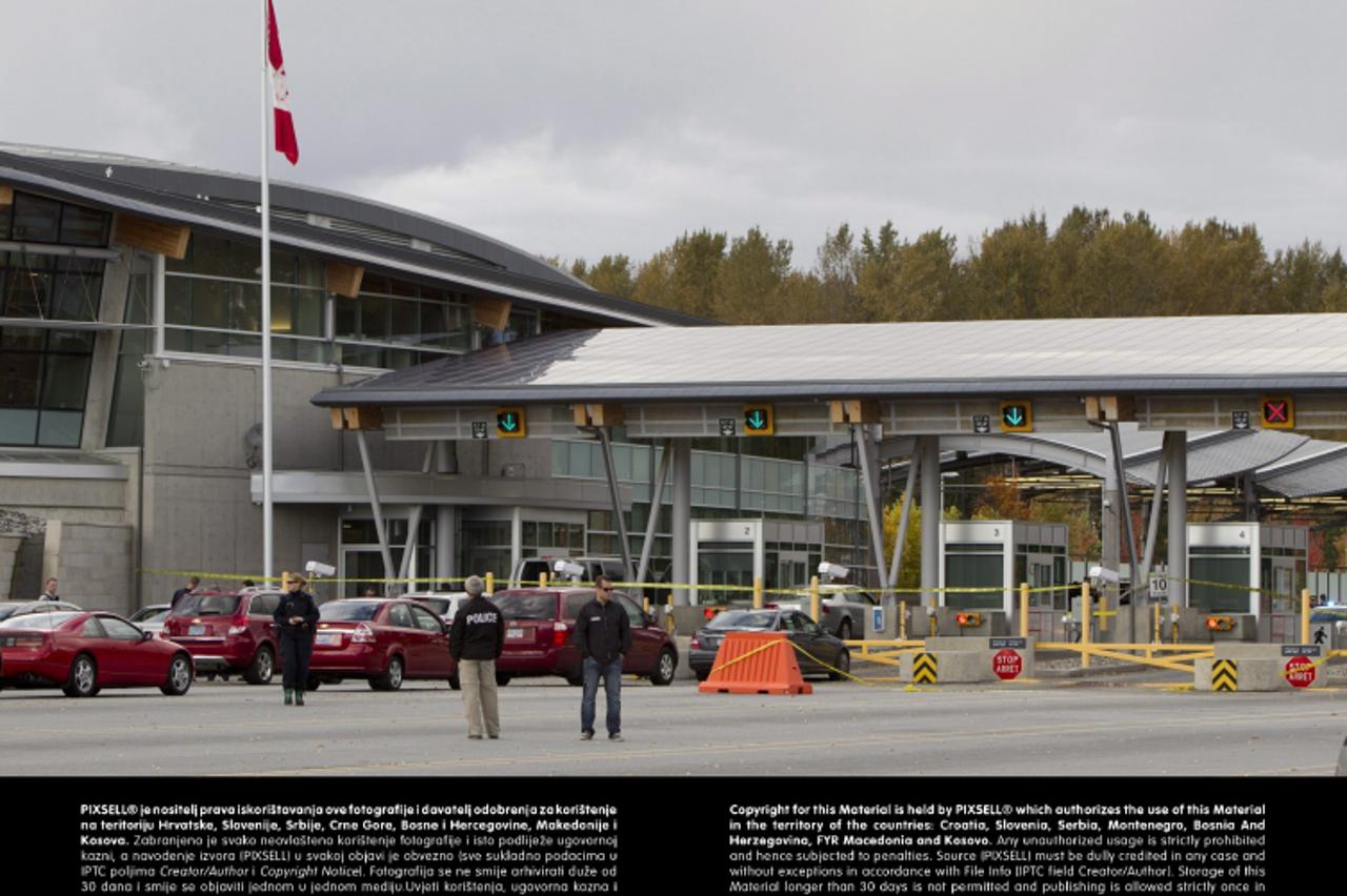 'Police investigate the scene of a shooting at the Blaine, Wash./Surrey, British Columbia border crossing, Tuesday, Oct. 16, 2012, in Surrey. Royal Canadian Mounted Police Cpl. Bert Paquet says a bord