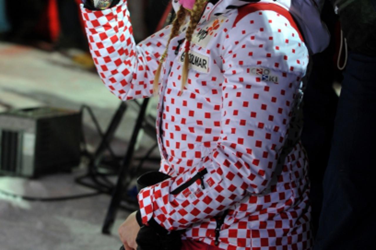 'Former Croatian ski legend Janica Kostelic takes picture of her brother Ivica (not pictured) during the podium ceremony after the men\'s Alpine World Cup slalom race on Sljeme mountain aboveZagreb on