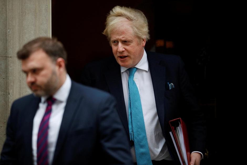 British PM Johnson walks outside Downing Street in London