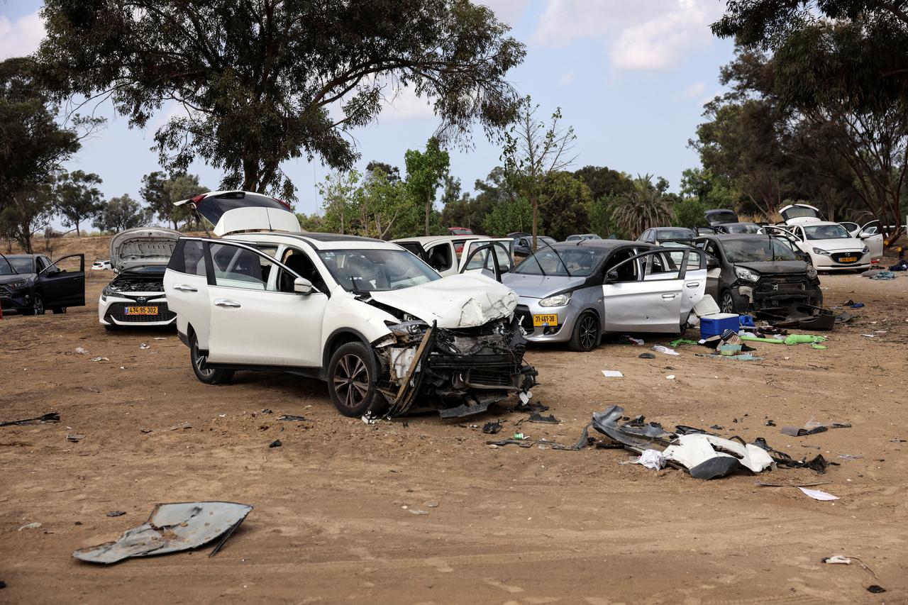 Burnt cars are abandoned in a carpark near where a festival was held before an attack by Hamas gunmen from Gaza that left at least 260 people dead, by Israel's border with Gaza in southern Israel