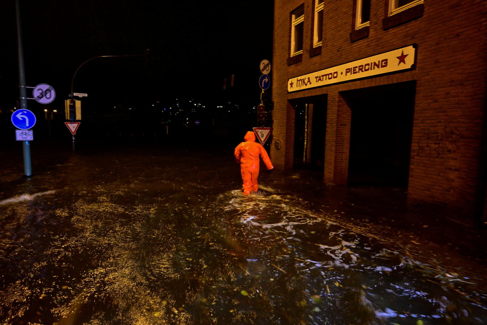 A person wades through the flooded street as the Baltic Sea coast is hit by heavy storms, in Flensburg, northern Germany, October 20, 2023. REUTERS/Fabian Bimmer Photo: Fabian Bimmer/REUTERS