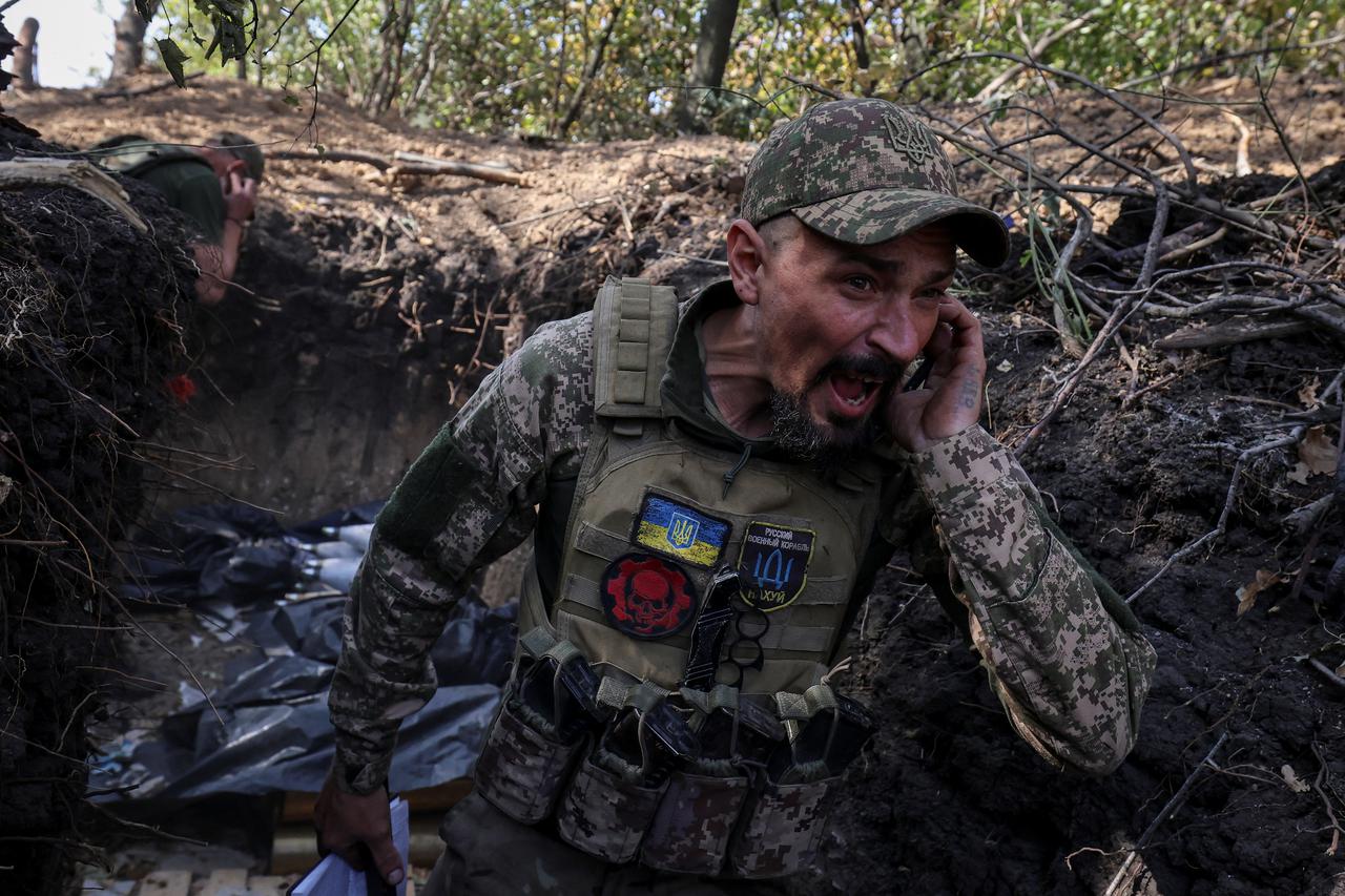 Ukrainian servicemen fire a self-propelled howitzer towards Russian troops at a frontline near the town of Pokrovsk