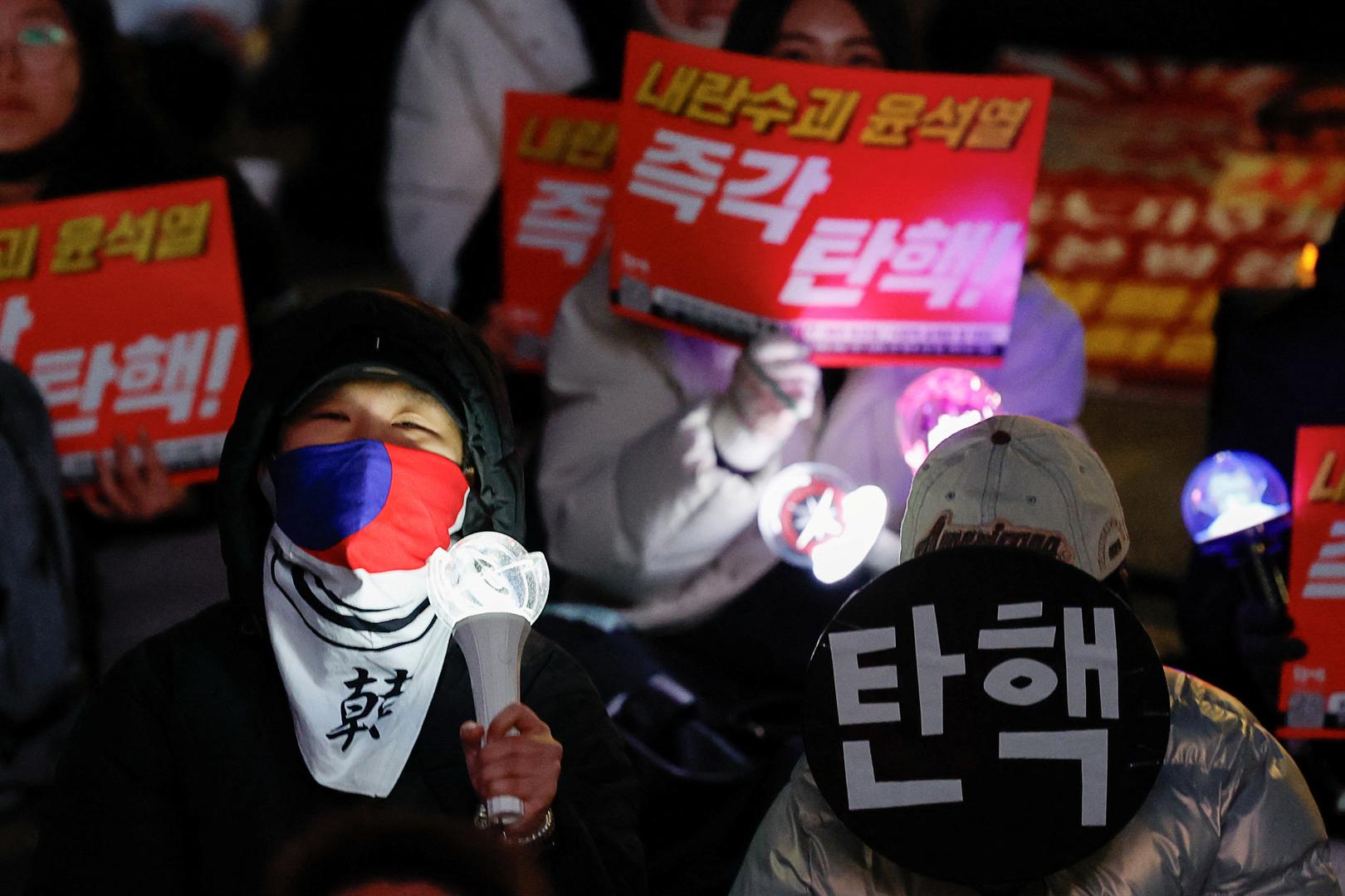 A protester holds a sign that reads "impeachment", during a rally calling for the impeachment of South Korean President Yoon Suk Yeol, who declared martial law, which was reversed hours later, near the National Assembly in Seoul, South Korea, December 8, 2024. REUTERS/Kim Kyung-Hoon Photo: KIM KYUNG-HOON/REUTERS