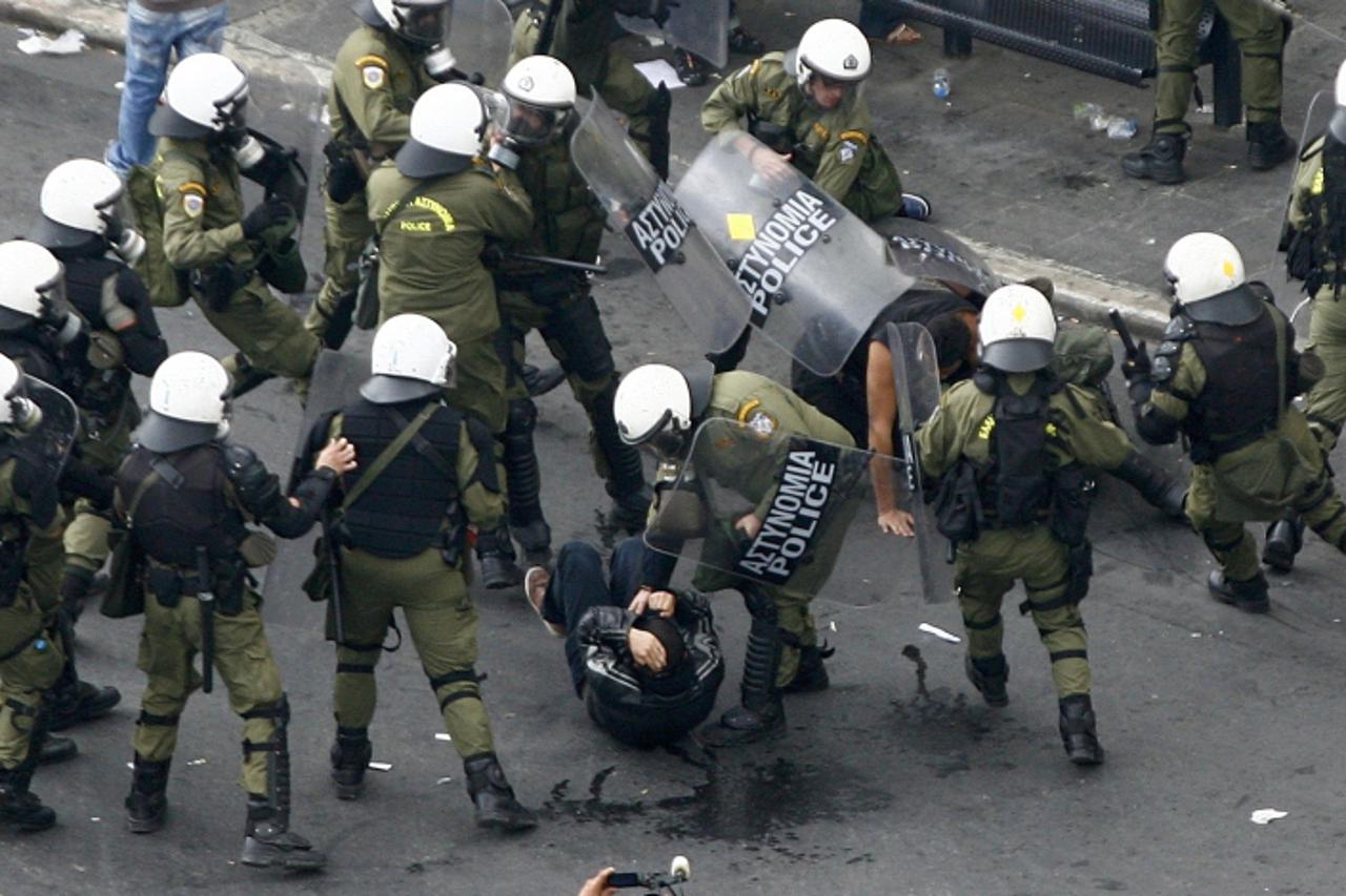 'Demonstrators are arrested by riot policemen during a protest against the visit to Greece by Germany\'s Chancellor Angela Merkel in Athens, October 9, 2012. Germany\'s Angela Merkel arrived in Greece