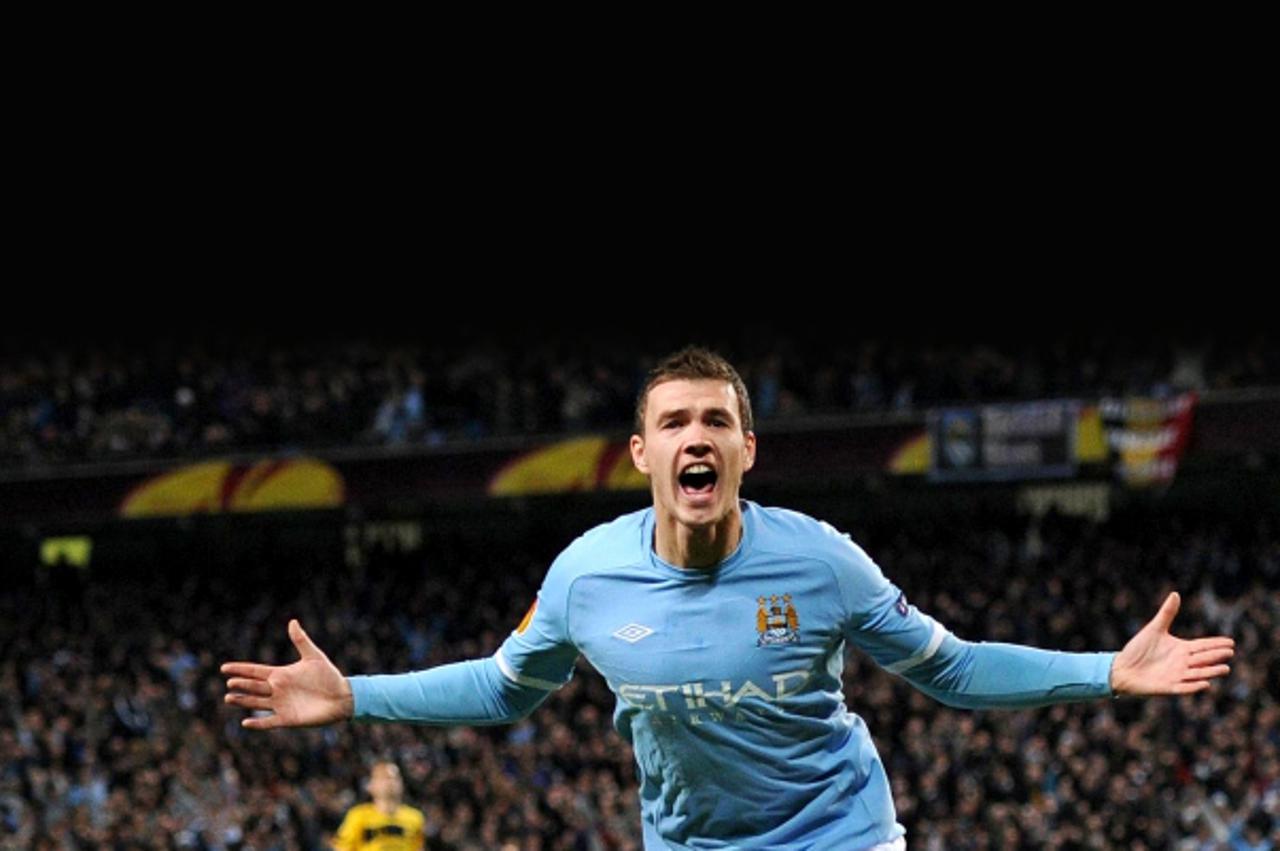 '*ALTERNATIVE CROP* Manchester City\'s Edin Dzeko celebrates scoring their first goal of the game during the UEFA Europa League match at the City of Manchester Stadium, Manchester. Photo: Press Associ