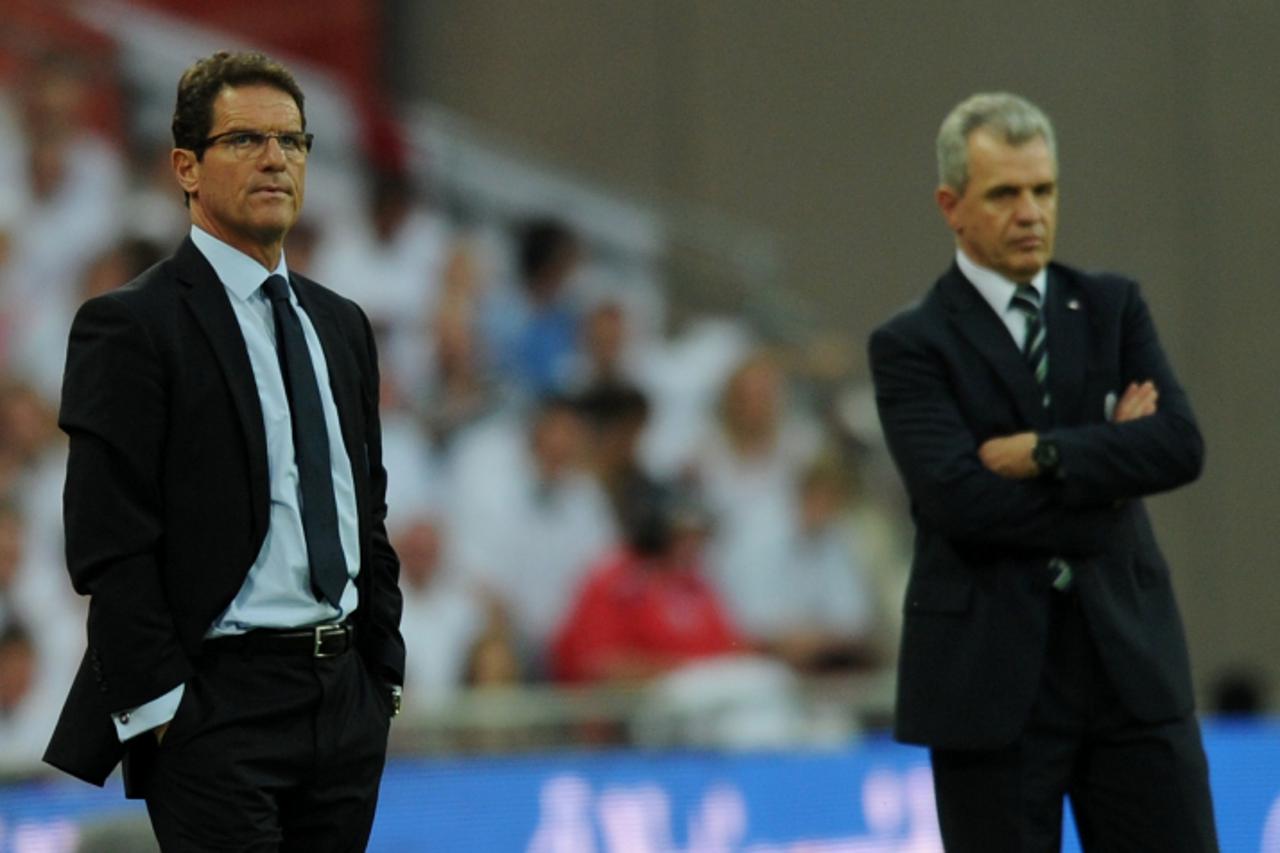 \'England\'s coach Fabio Capello (L) and Mexico\'s coach Javier Aguirre watch their teams during their international friendly football match against at Wembley Stadium in London on May 24, 2010   AFP 