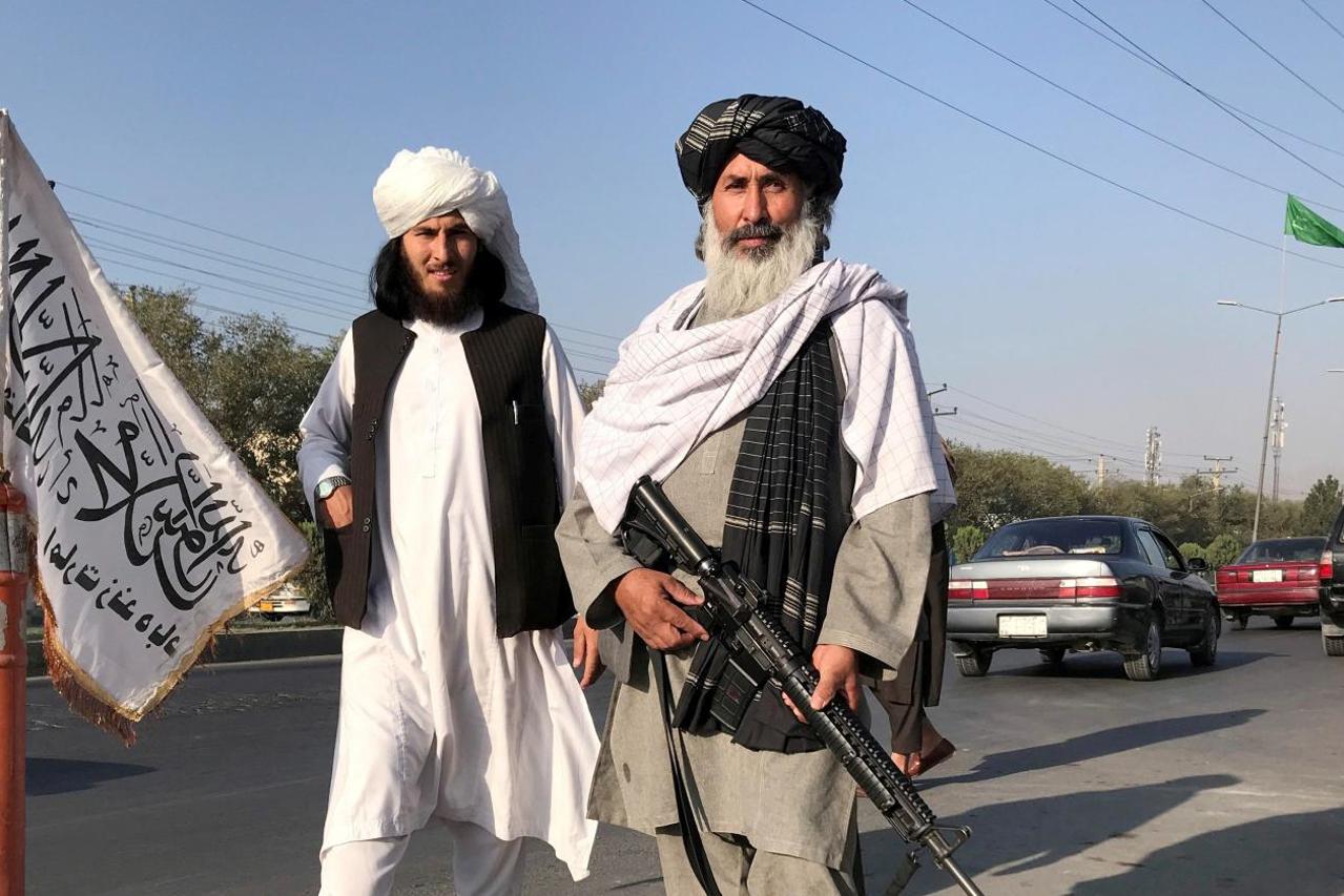 FILE PHOTO: Taliban fighter stand outside the Interior Ministry in Kabul