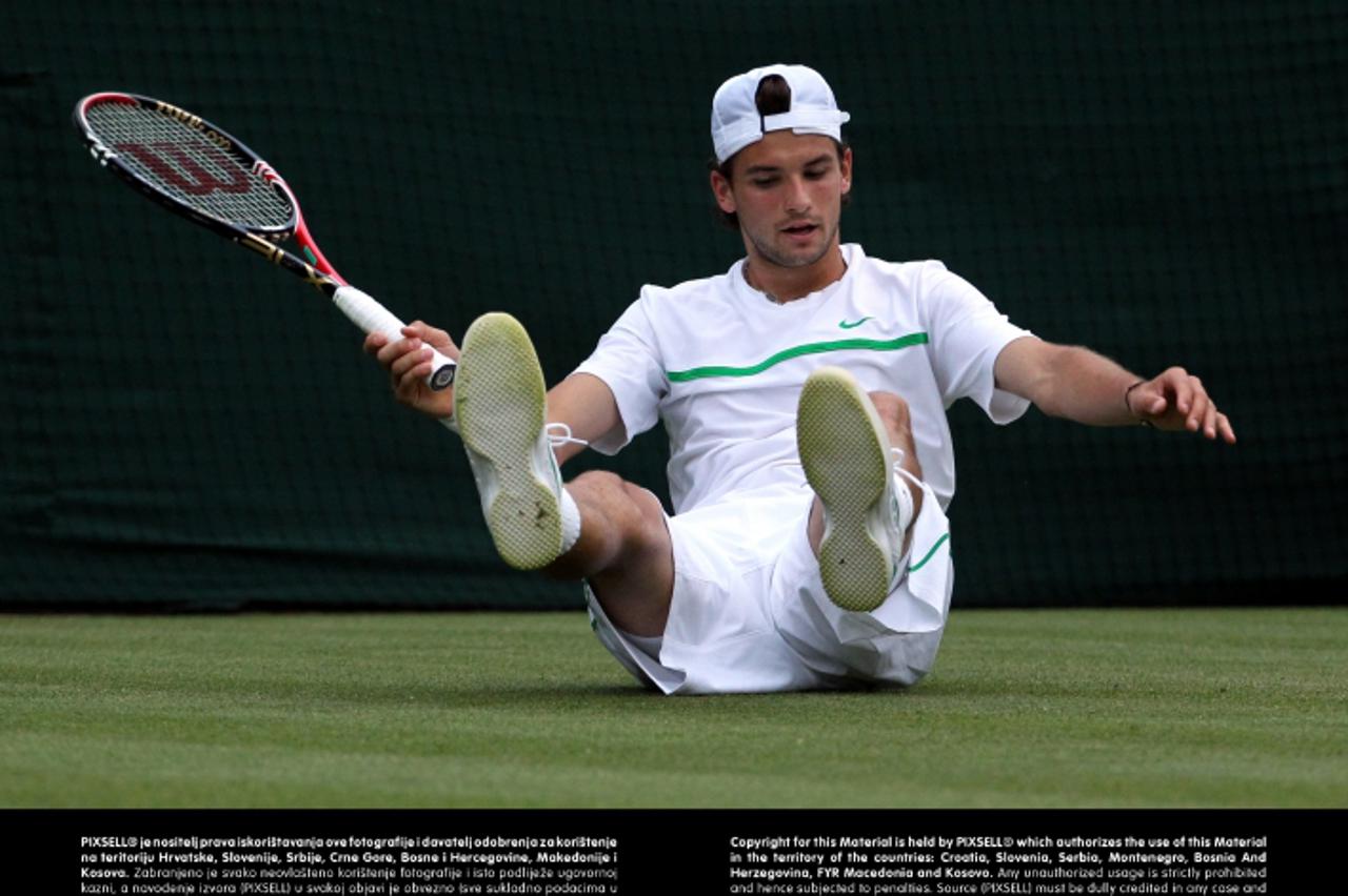 'Bulgaria\'s Grigor Dimitrov looks dejected during his match with France\'s Jo Wilfried Tsonga on day four of the 2011 Wimbledon Championships at the All England Lawn Tennis and Croquet Club, Wimbledo