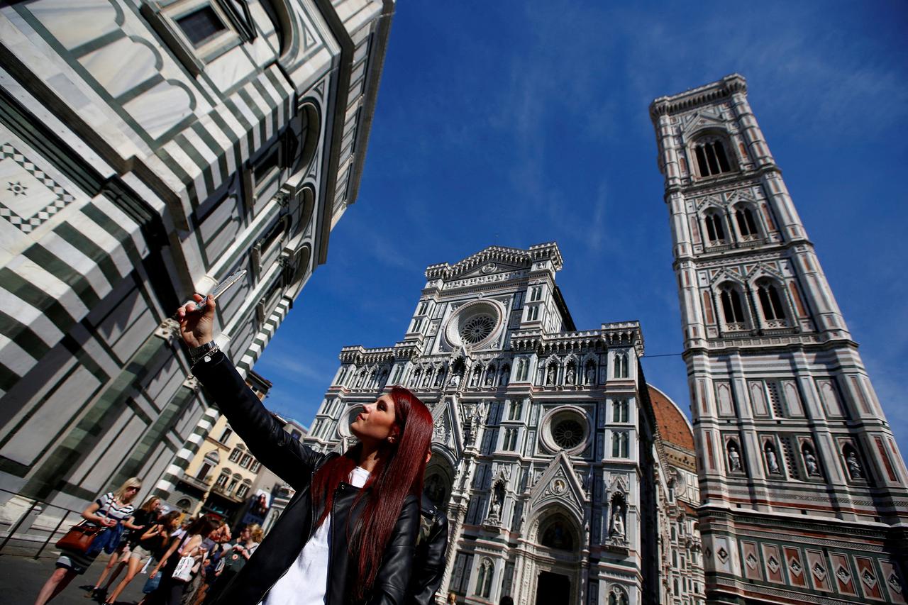 FILE PHOTO: Tourist takes selfie in Florence