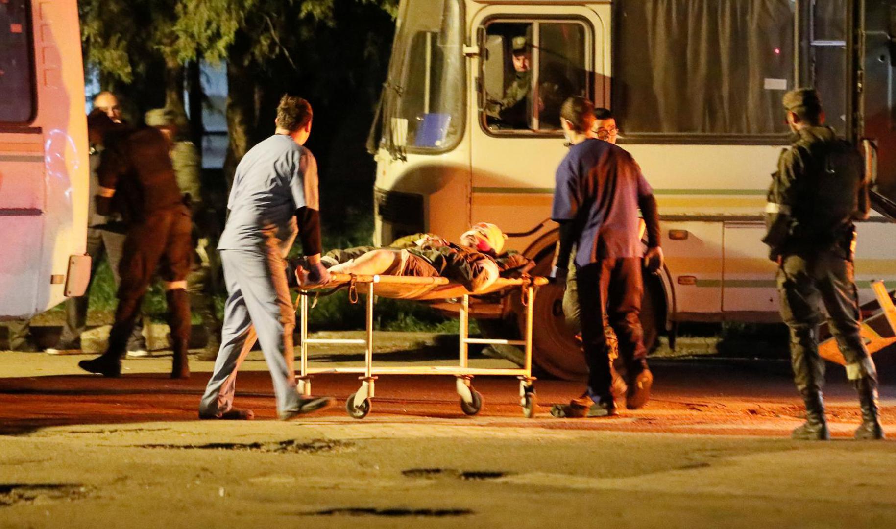 A wounded service member of Ukrainian forces from the besieged Azovstal steel mill in Mariupol is transported out of a bus on a stretcher under escort of the pro-Russian military in the course of Ukraine-Russia conflict upon arrival in Novoazovsk, Ukraine May 16, 2022. REUTERS/Alexander Ermochenko Photo: Alexander Ermochenko/REUTERS