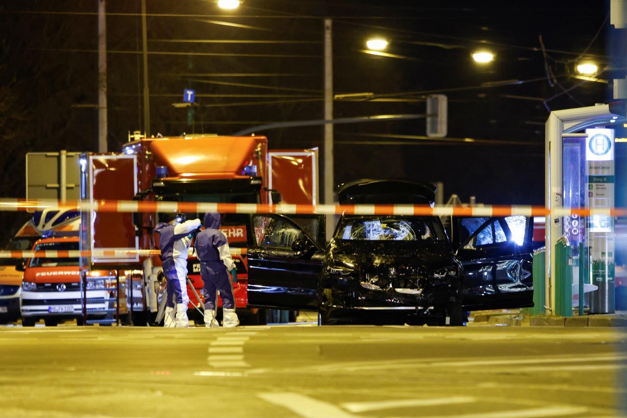 Emergency personnel work next to a damaged car that drove into a group of people, according to local media, in Magdeburg