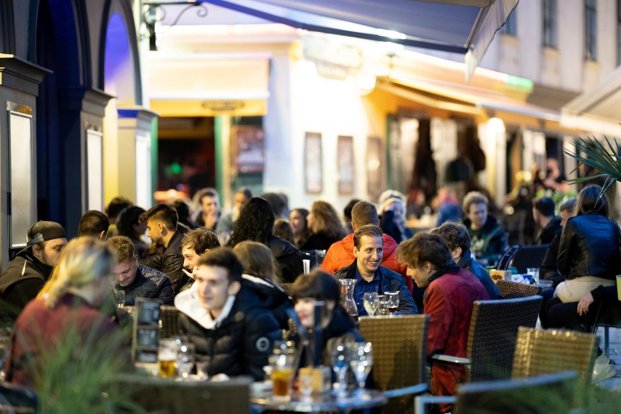 People enjoy an evening drink after Austria eases its COVID-19 restrictions