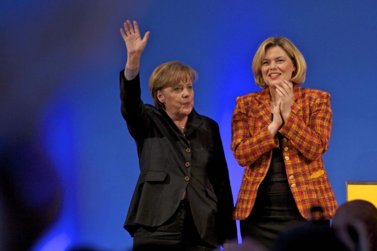 'German Chancellor and head of the Christian Democratic Union Party (CDU) Angela Merkel (L) waves during a meeting to support Julia Kloeckner, top candidate of CDU for the upcoming state elections in 