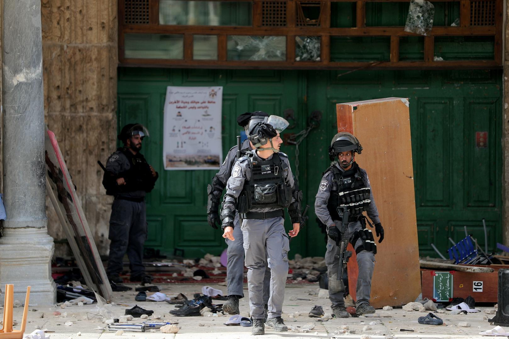 Israeli police clash with Palestinians at the compound that houses Al-Aqsa Mosque in Jerusalem Israeli police walk in front of the closed doors of Al-Aqsa Mosque during clashes with Palestinians at the compound that houses  known to Muslims as Noble Sanctuary and to Jews as Temple Mount, in Jerusalem's Old City, May 10, 2021. REUTERS/Ammar Awad AMMAR AWAD