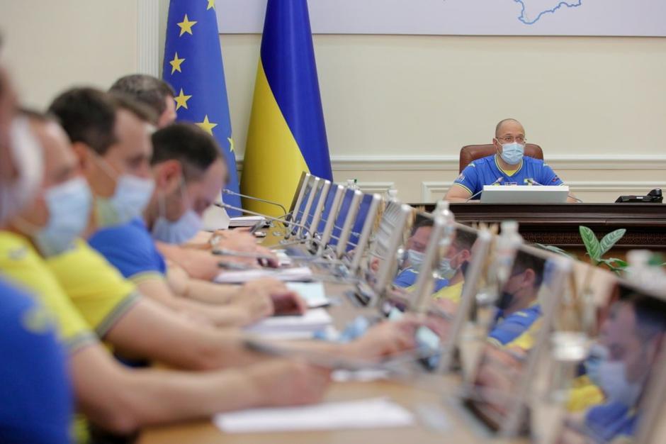 Ukrainian ministers wear the soccer national team's jerseys during a meeting of the government in Kyiv