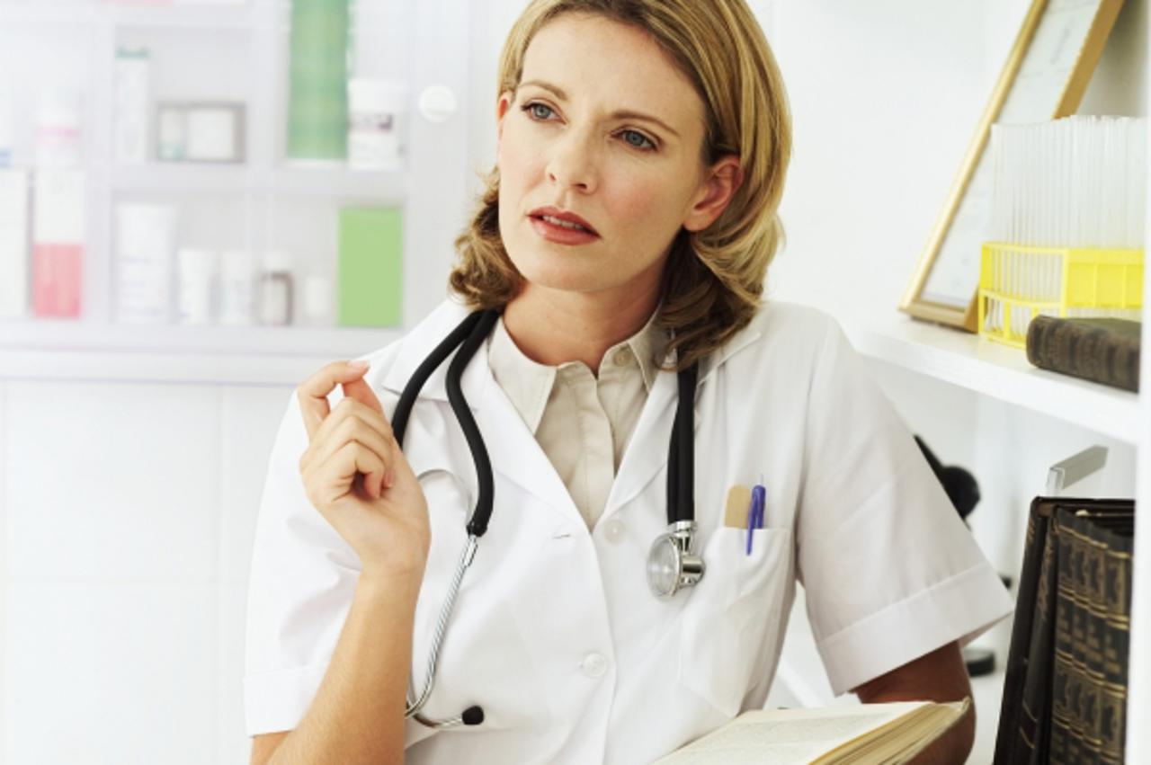 'female doctor holding a book'