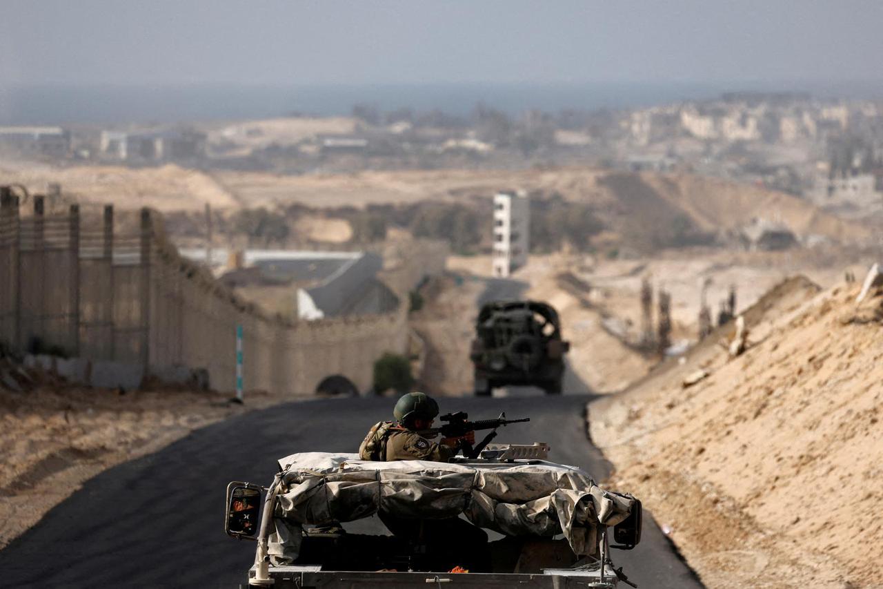 FILE PHOTO: Israeli military vehicles drive through the Philadelphi Corridor area in southern Gaza