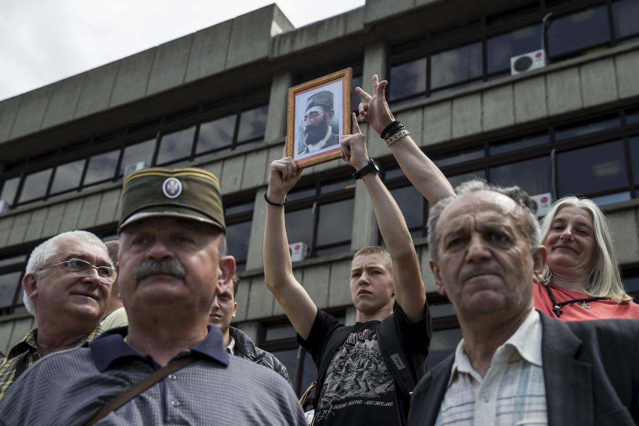 Supporters of Dragoljub 'Draza' Mihailovic hold his picture as they celebrate his rehabilitation in front of a court in Belgrade, Serbia, May 14, 2015. A Serbian court on Thursday rehabilitated World War Two royalist commander and convicted Nazi collabora