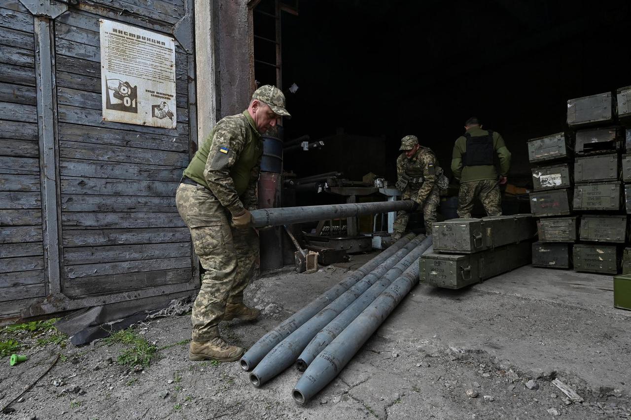 Ukrainian servicemen prepare MLRS shells near a frontline in Zaporizhzhia region