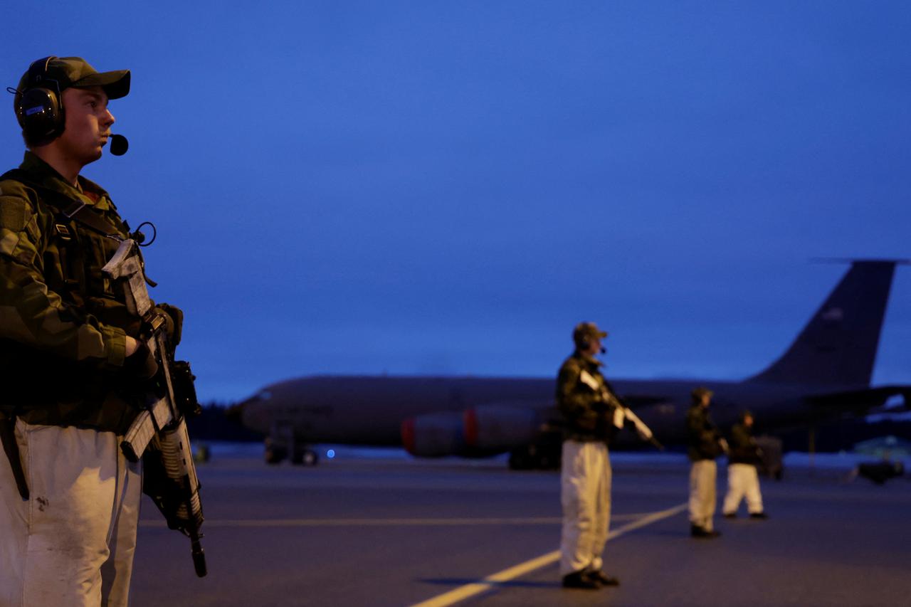 Swedish army soldiers stand on the tarmac at Kallax Air Base